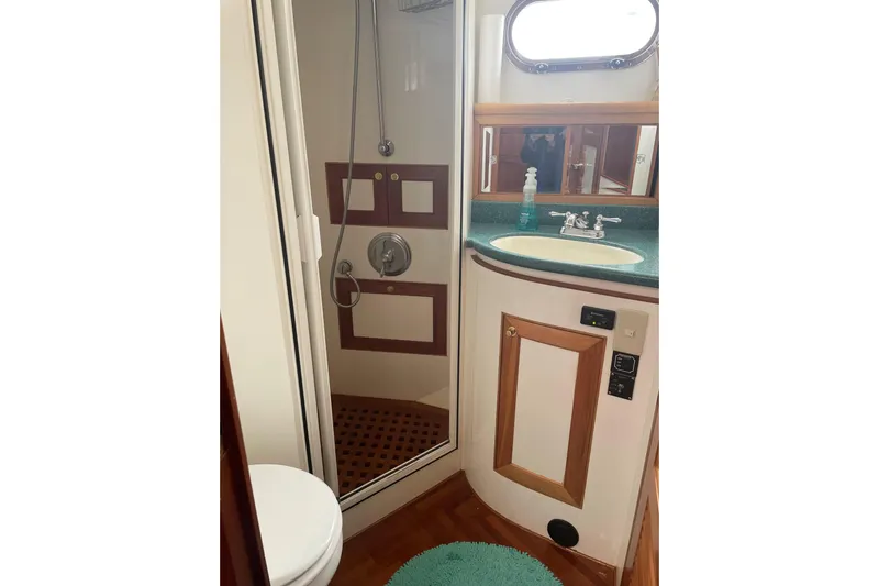 Eagles Soar Yacht Photos Pics Bathroom interior of 2000 Hampton 490 yacht with shower, sink, and toilet.