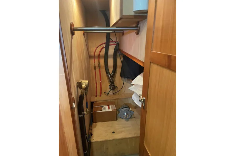 Eagles Soar Yacht Photos Pics Utility room in a 2000 Hampton 490 yacht with pipes and storage.