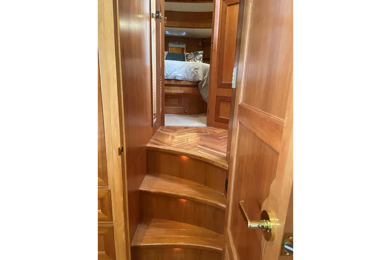 Eagles Soar Yacht Photos Pics Interior of 2000 Hampton 490 yacht with wooden stairs leading to bedroom.