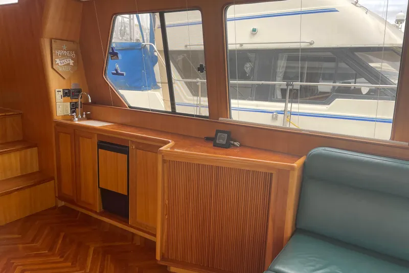 Eagles Soar Yacht Photos Pics Interior of 2000 Hampton 490 yacht with wood cabinetry and seating.