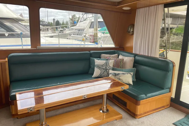 Eagles Soar Yacht Photos Pics Luxurious interior of a 2000 Hampton 490 yacht with green seating and decorative pillows.