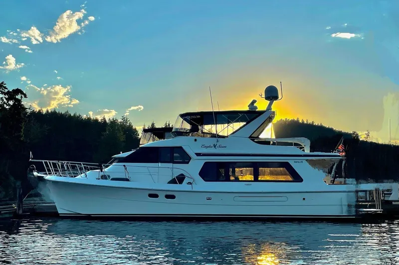 Eagles Soar Yacht Photos Pics Hampton 490 yacht from 2000 at sunset, docked on calm water.