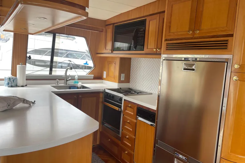 Eagles Soar Yacht Photos Pics Luxurious kitchen interior of a 2000 Hampton 490 yacht with modern appliances.