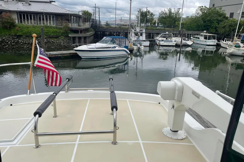 Eagles Soar Yacht Photos Pics Hampton 490 yacht deck with American flag, docked in a marina, 2000 model.