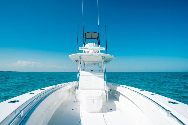  Yacht Photos Pics 2023 Contender 39 ST boat cruising on clear blue ocean waters.