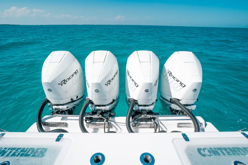  Yacht Photos Pics 2023 Contender 39 ST boat with four powerful outboard engines on turquoise water.