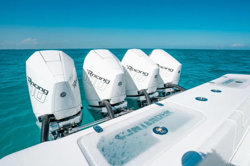  Yacht Photos Pics 2023 Contender 39 ST boat with four powerful outboard engines on clear blue water.