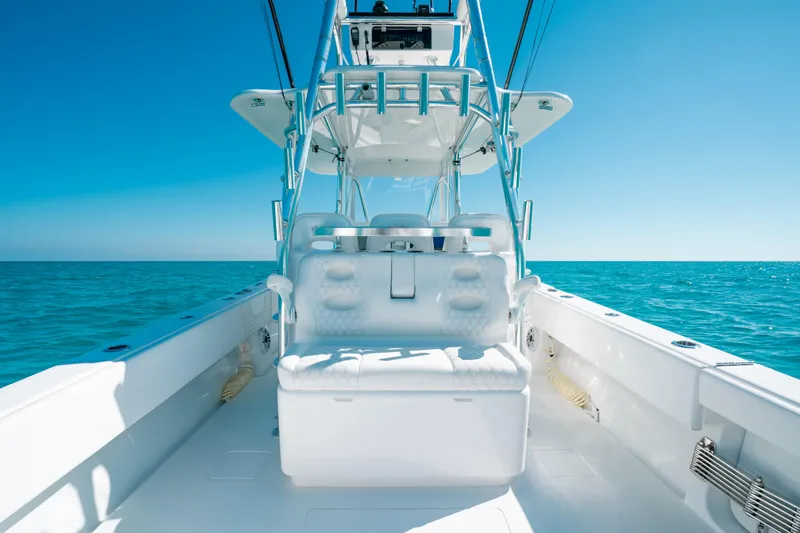  Yacht Photos Pics 2023 Contender 39 ST boat on open sea under clear blue sky.