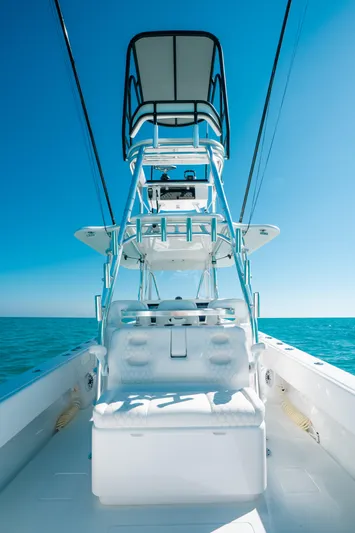  Yacht Photos Pics 2023 Contender 39 ST boat with tower against clear blue sky and ocean.