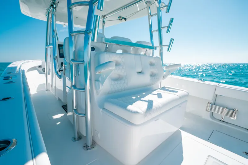  Yacht Photos Pics 2023 Contender 39 ST boat interior with white seating, ocean view, and clear blue sky.