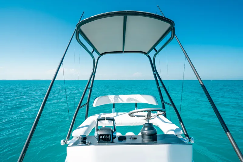  Yacht Photos Pics 2023 Contender 39 ST boat helm with ocean view and clear blue sky.