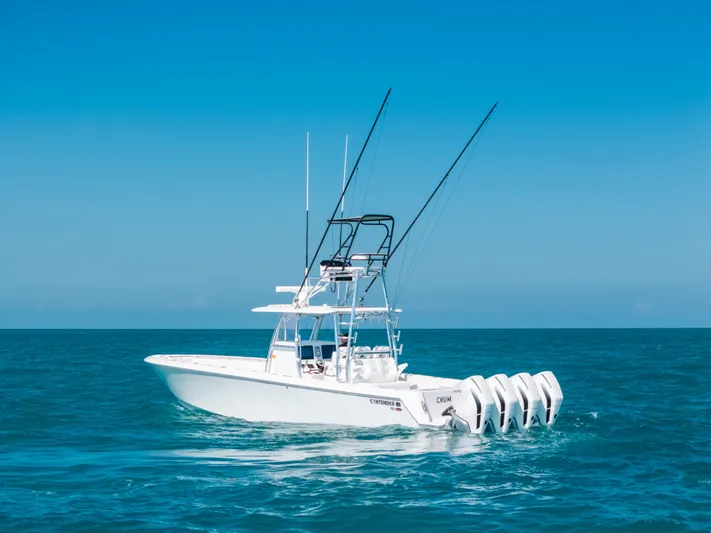  Yacht Photos Pics 2023 Contender 39 ST boat on open sea with clear blue sky.