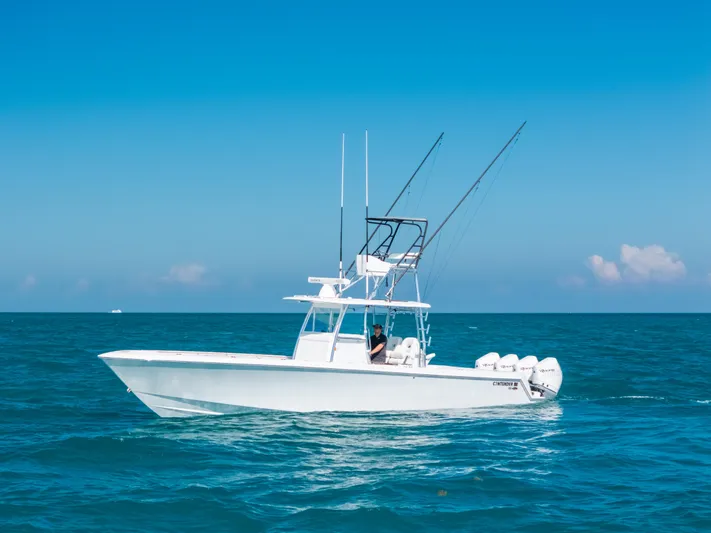  Yacht Photos Pics 2023 Contender 39 ST boat on open sea under clear blue sky.