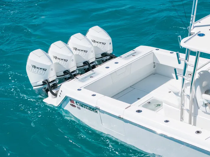  Yacht Photos Pics 2023 Contender 39 ST boat with four powerful outboard engines on turquoise water.