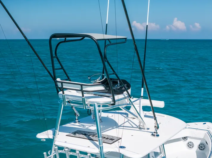  Yacht Photos Pics 2023 Contender 39 ST boat with elevated helm station on open sea.