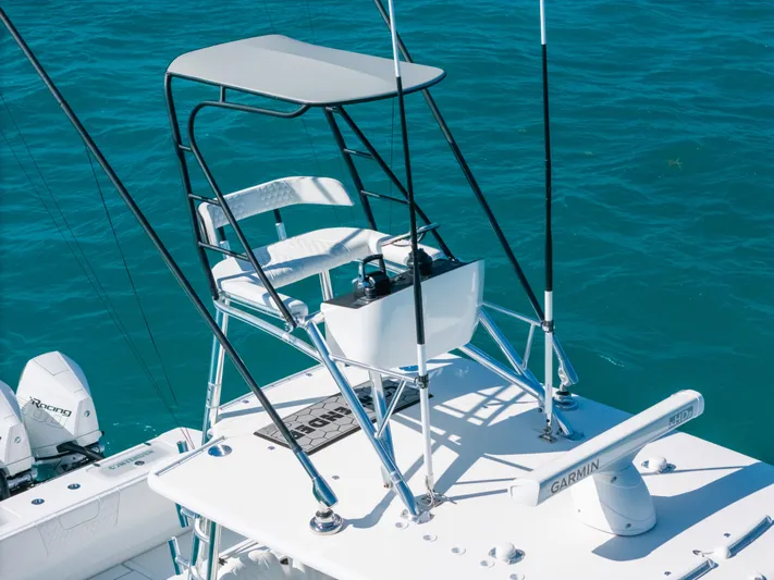  Yacht Photos Pics 2023 Contender 39 ST boat with elevated helm station on blue ocean water.