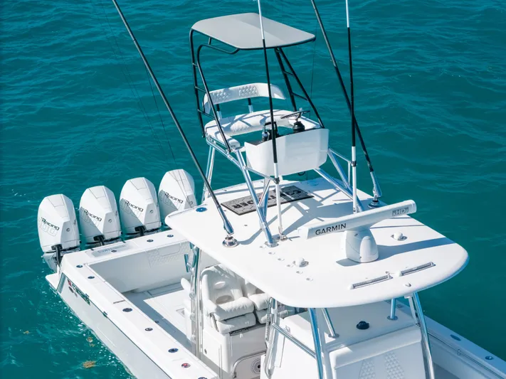  Yacht Photos Pics 2023 Contender 39 ST boat with four engines on turquoise water.