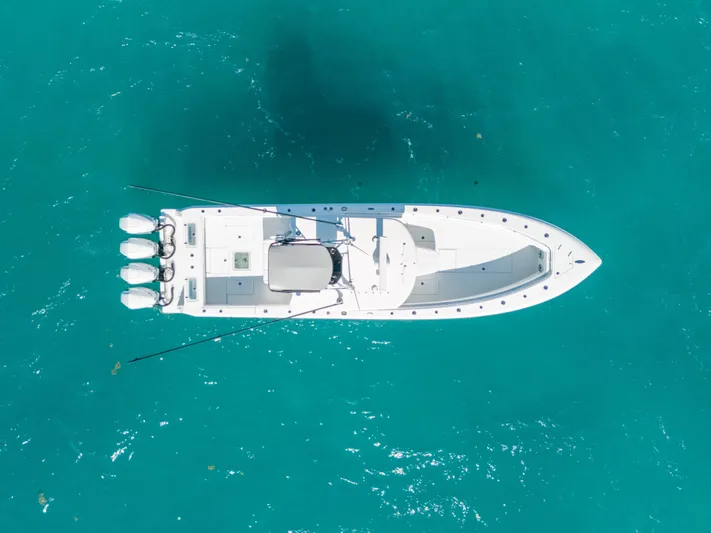  Yacht Photos Pics Aerial view of 2023 Contender 39 ST boat on clear turquoise water.