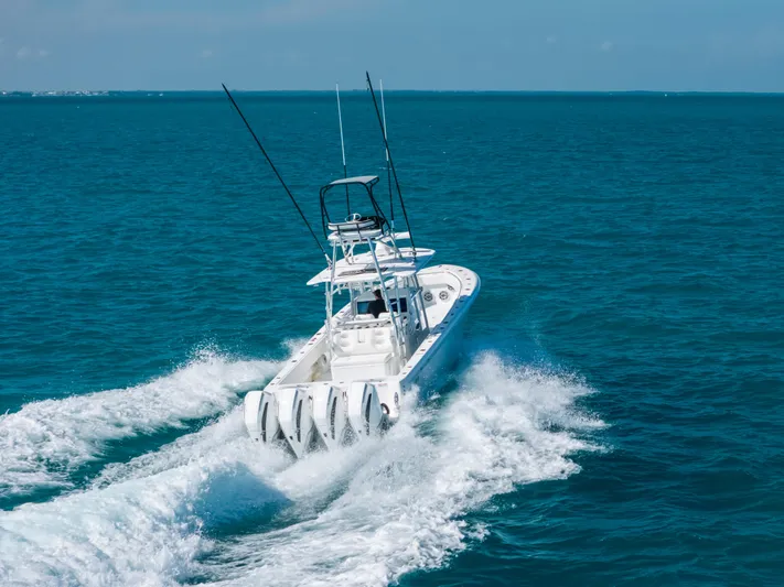  Yacht Photos Pics 2023 Contender 39 ST boat cruising on open ocean waters.