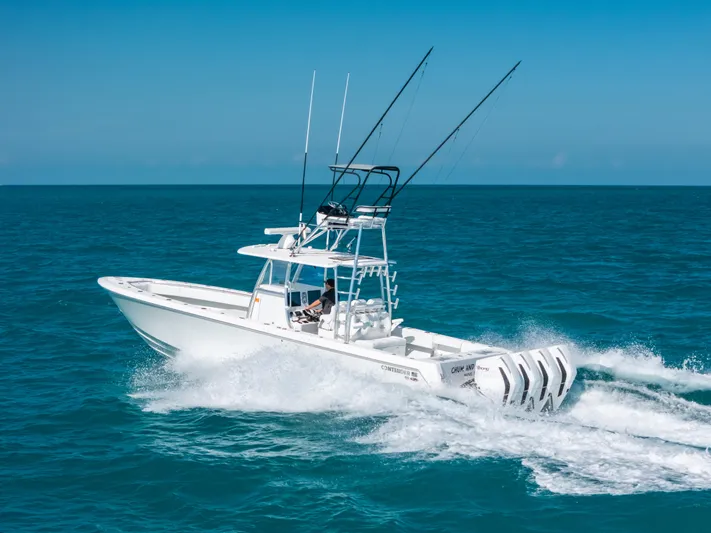  Yacht Photos Pics 2023 Contender 39 ST boat cruising on open ocean with multiple outboard engines.