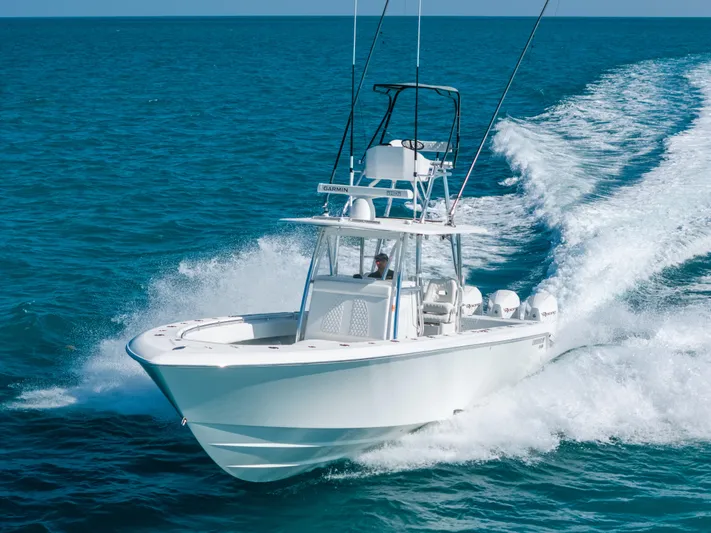  Yacht Photos Pics 2023 Contender 39 ST boat cruising on open ocean waters.