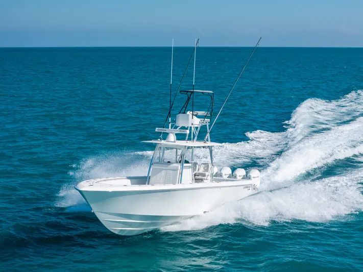  Yacht Photos Pics 2023 Contender 39 ST boat cruising on open ocean waters.