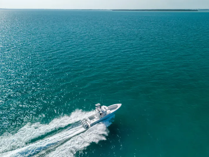  Yacht Photos Pics 2023 Contender 39 ST boat cruising on open blue ocean waters.