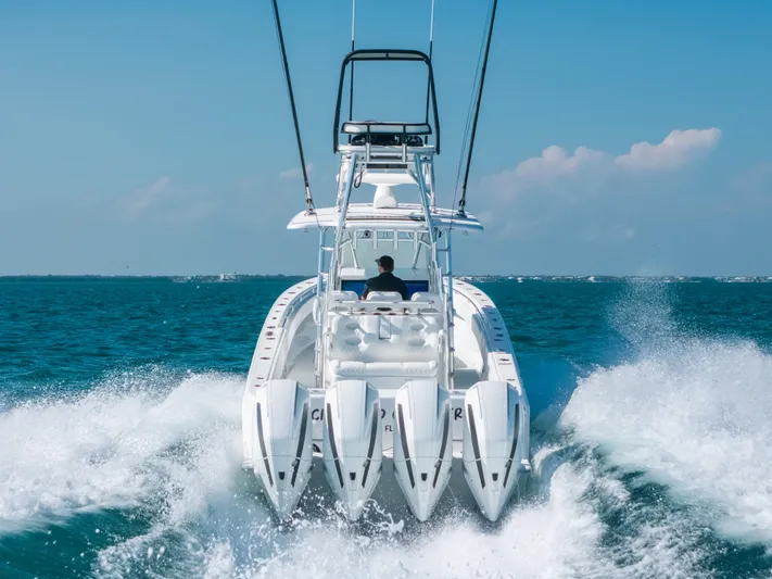  Yacht Photos Pics 2023 Contender 39 ST boat cruising on open water with four engines.