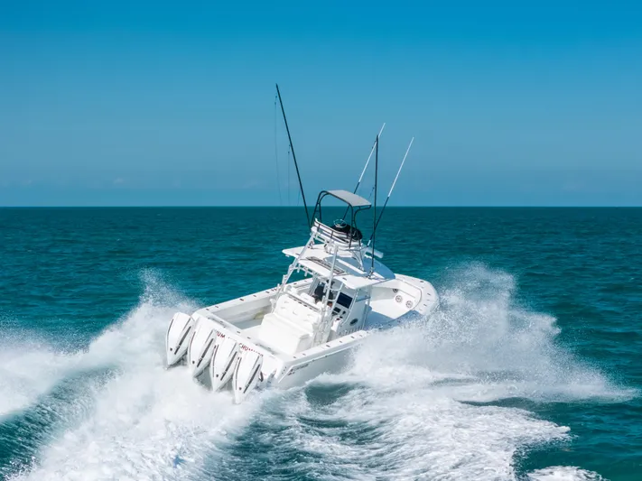  Yacht Photos Pics 2023 Contender 39 ST boat navigating ocean waves at high speed.
