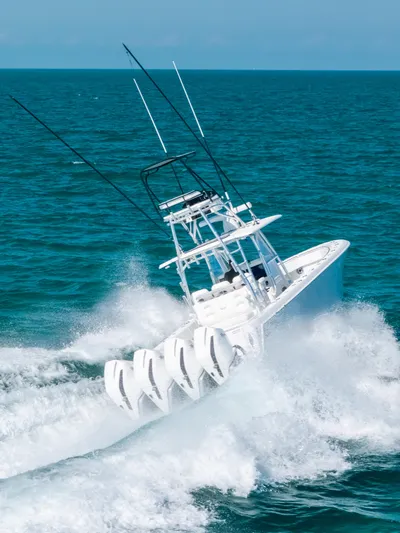  Yacht Photos Pics 2023 Contender 39 ST boat navigating ocean waves at high speed.