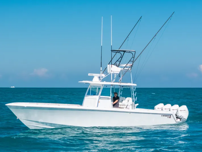  Yacht Photos Pics 2023 Contender 39 ST boat on open sea with clear blue sky.