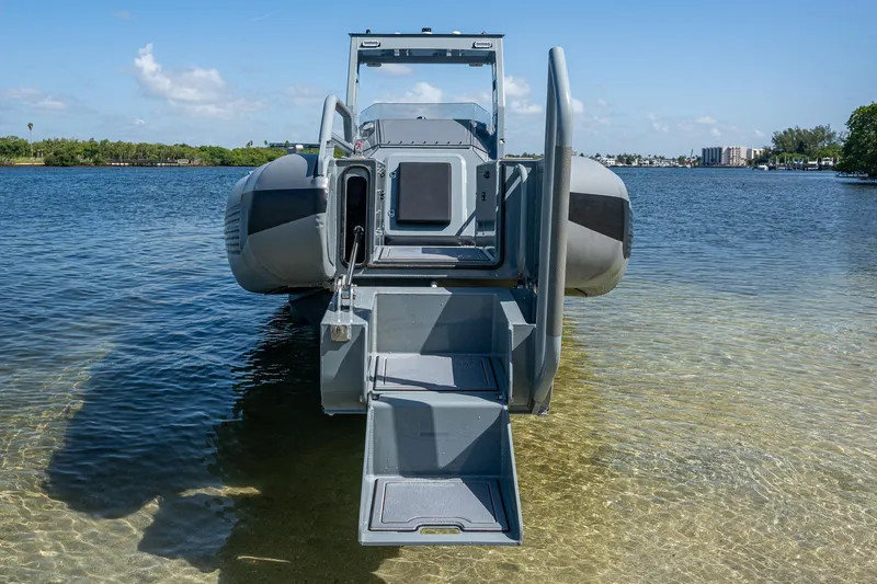  Yacht Photos Pics 2023 SAFE Boats Interceptor in shallow water, rear view with open ramp.