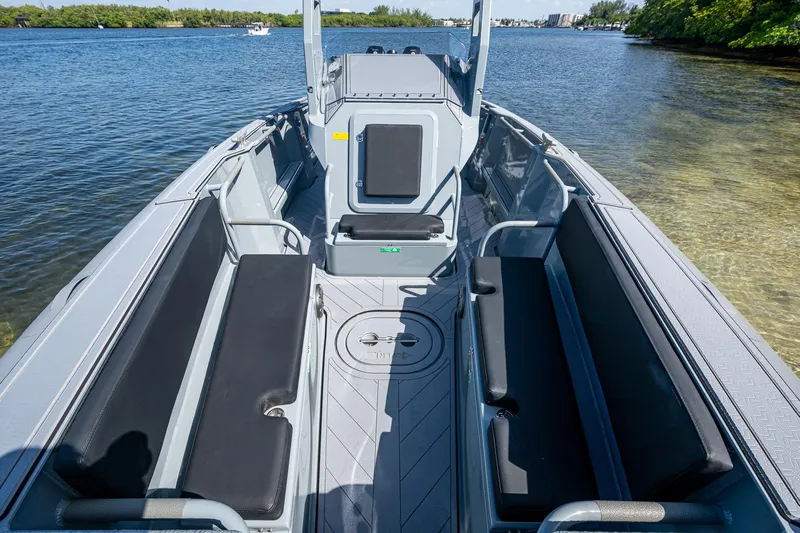  Yacht Photos Pics 2023 SAFE Boats Interceptor interior with seating, docked on calm water.