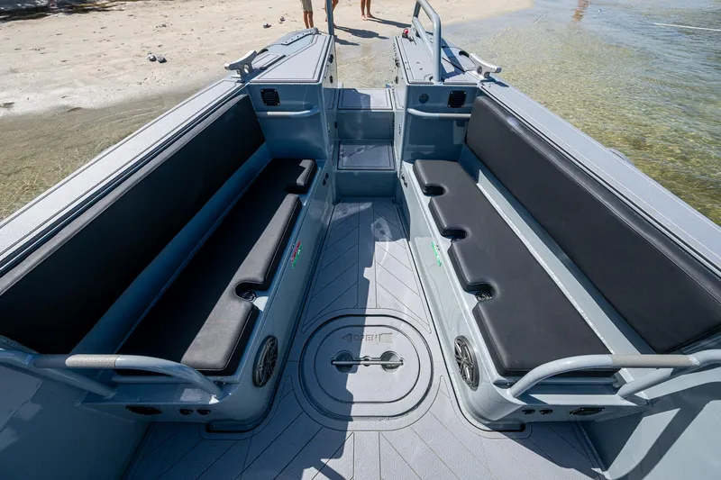  Yacht Photos Pics 2023 SAFE Boats Interceptor interior with seating, docked on a sandy beach.