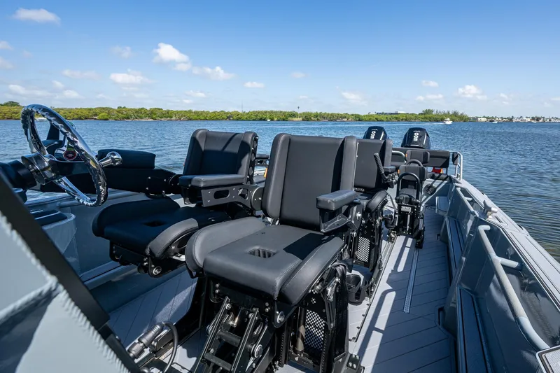  Yacht Photos Pics 2023 SAFE Boats Interceptor with advanced seating, cruising on a serene waterway under a clear blue sky.