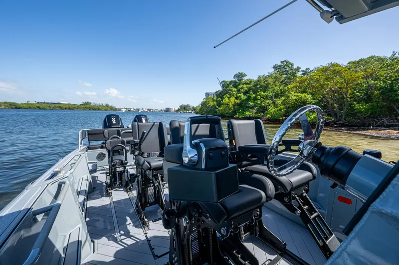  Yacht Photos Pics 2023 SAFE Boats Interceptor on water, featuring modern seating and steering wheel.