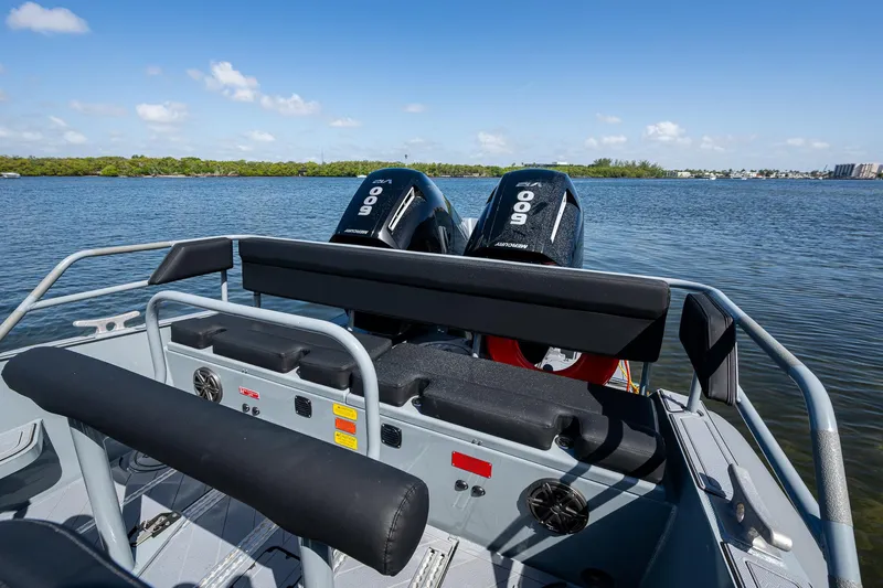  Yacht Photos Pics 2023 SAFE Boats Interceptor on water, featuring dual Mercury engines, clear sky, and scenic shoreline.