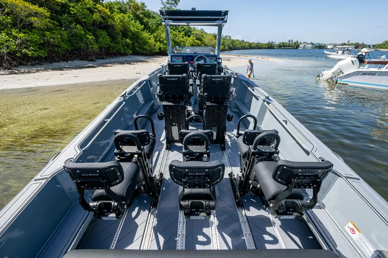  Yacht Photos Pics 2023 SAFE Boats Interceptor with Allsalt seats, docked near a sandy shore.