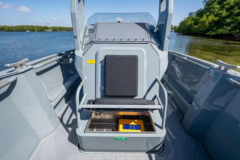  Yacht Photos Pics 2023 SAFE Boats Interceptor with open storage compartment on a calm waterway.