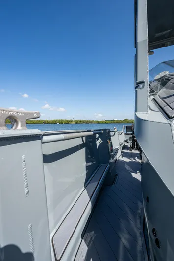  Yacht Photos Pics 2023 SAFE Boats Interceptor, sleek design, docked by calm waters under clear blue sky.