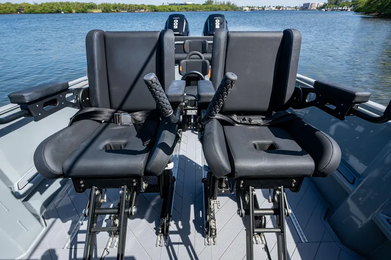  Yacht Photos Pics 2023 SAFE Boats Interceptor interior with dual seats on a calm water backdrop.