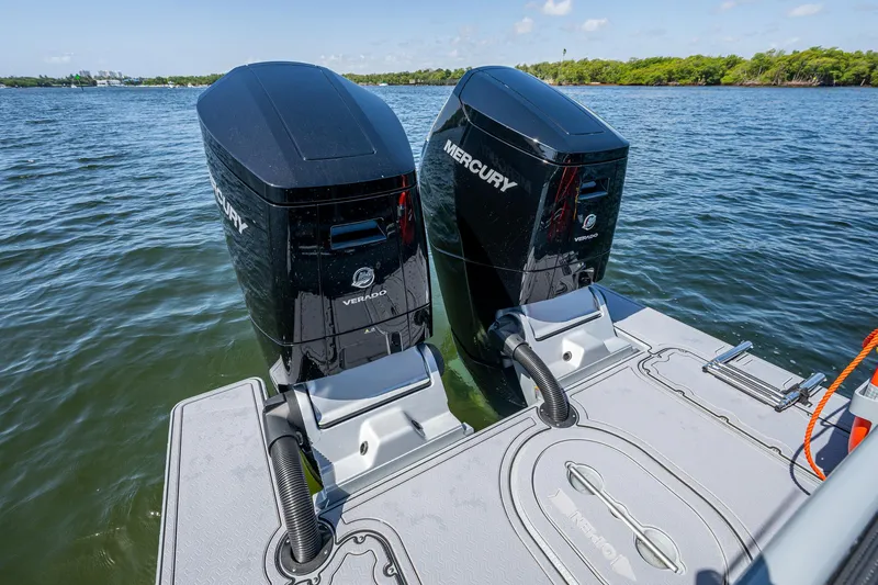  Yacht Photos Pics Twin Mercury Verado engines on a 2023 SAFE Boats Interceptor, docked on calm water.