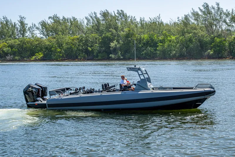  Yacht Photos Pics 2023 SAFE Boats Interceptor cruising on a calm river with lush green trees in the background.