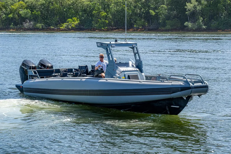  Yacht Photos Pics 2023 SAFE Boats Interceptor navigating calm waters with lush greenery in the background.