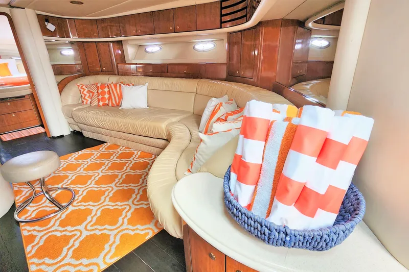 Euphoria 1 Yacht Photos Pics Luxurious interior of 2000 Sea Ray 540 Sundancer with orange accents and plush seating.