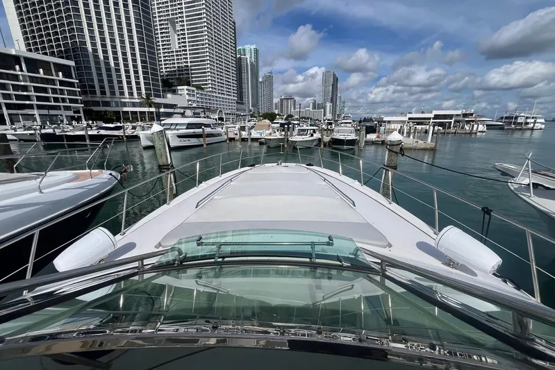 Euphoria 1 Yacht Photos Pics Sea Ray 540 Sundancer 2000 yacht docked in a marina with city skyline backdrop.