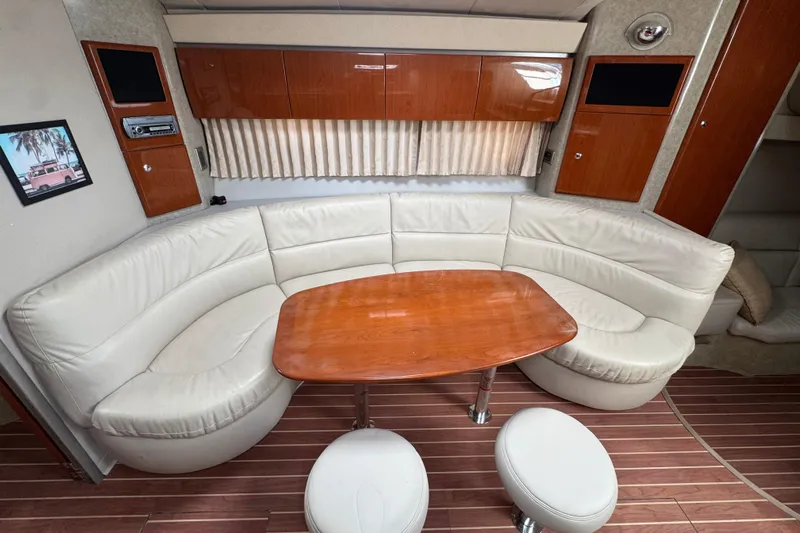  Yacht Photos Pics Interior of 2006 Formula 40 Performance Cruiser with leather seating and wooden table.
