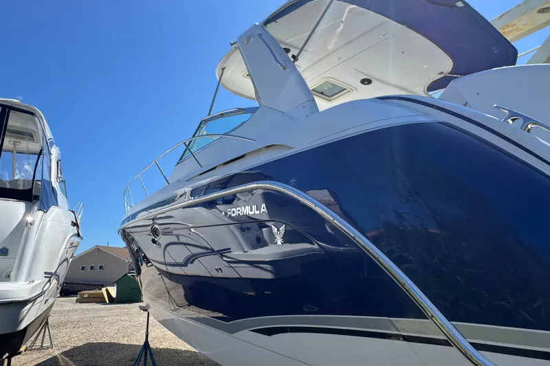  Yacht Photos Pics 2006 Formula 40 Performance Cruiser with sleek blue hull, docked under clear sky.