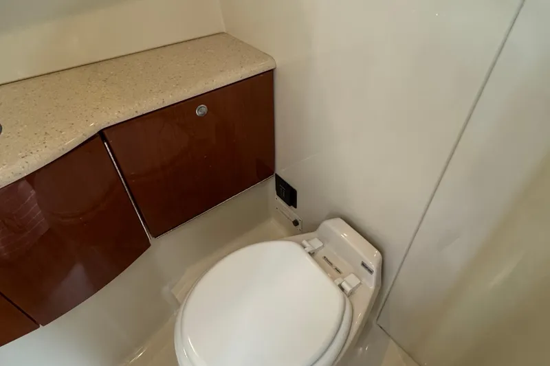  Yacht Photos Pics 2006 Formula 40 Performance Cruiser bathroom with modern fixtures and wooden cabinetry.