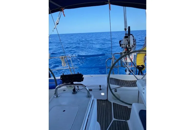 Kolibri Yacht Photos Pics Cockpit view of 2006 Jeanneau Sun Odyssey 45 sailing on open sea.